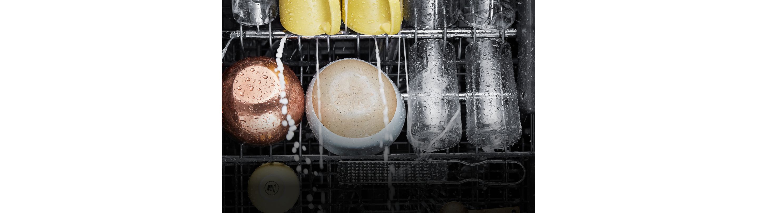 Water spraying on dishes in a KitchenAid® dishwasher,