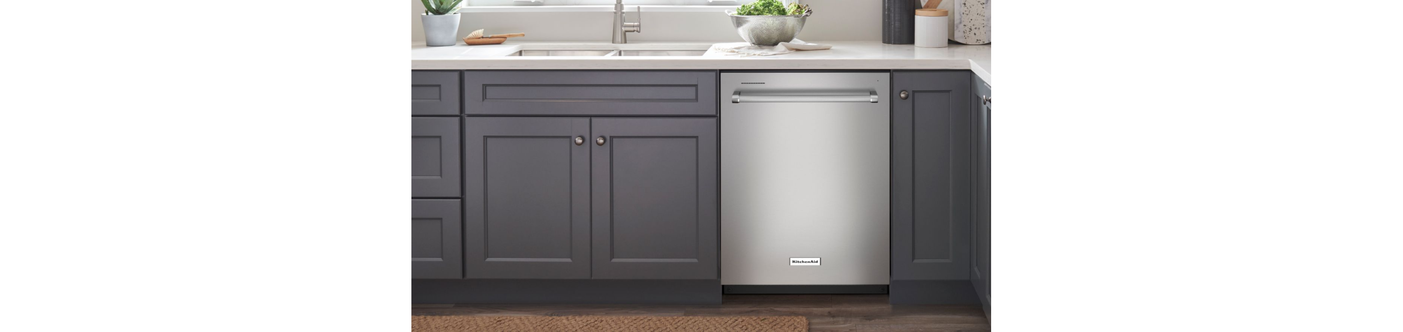 A dishwasher in a bank of cabinets