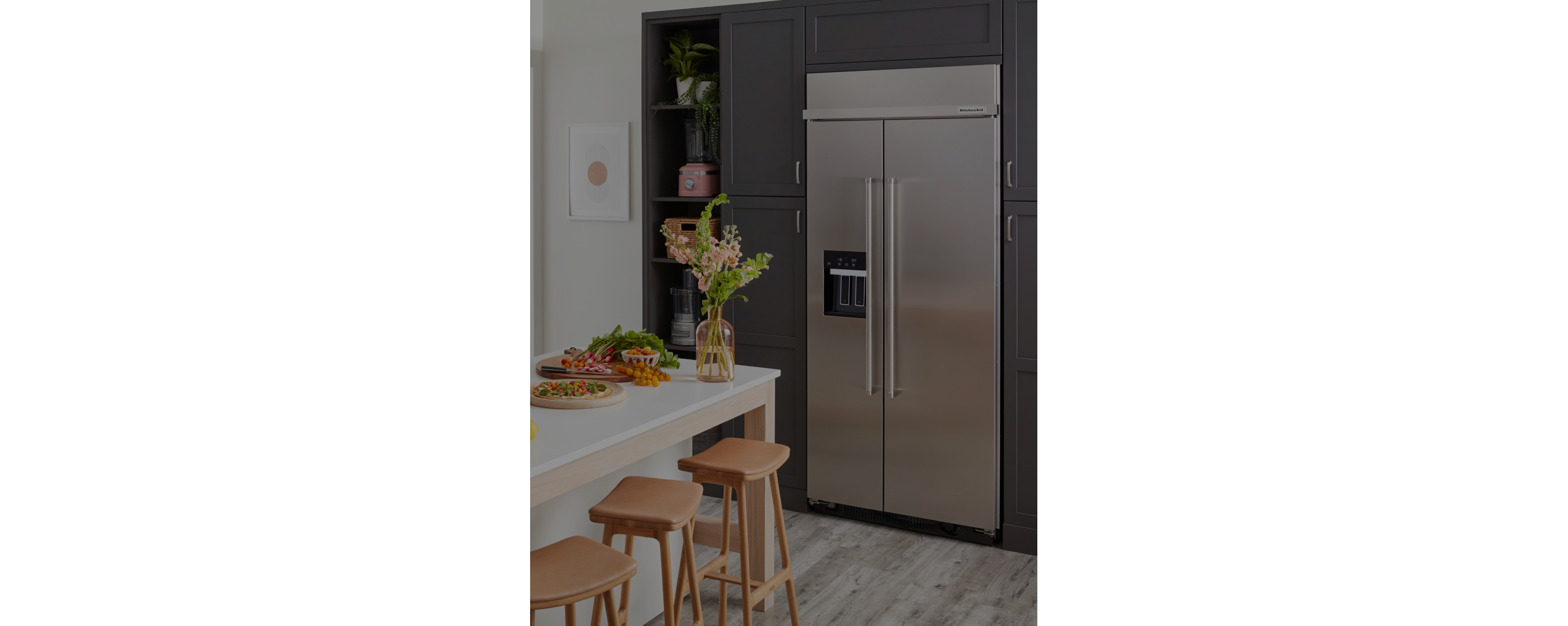 A KitchenAid® built-in refrigerator in a modern kitchen. 