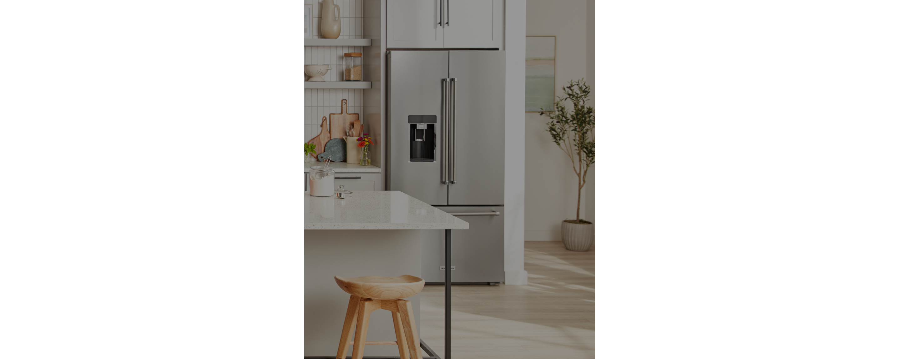 A KitchenAid® freestanding refrigerator in a light, bright kitchen. 