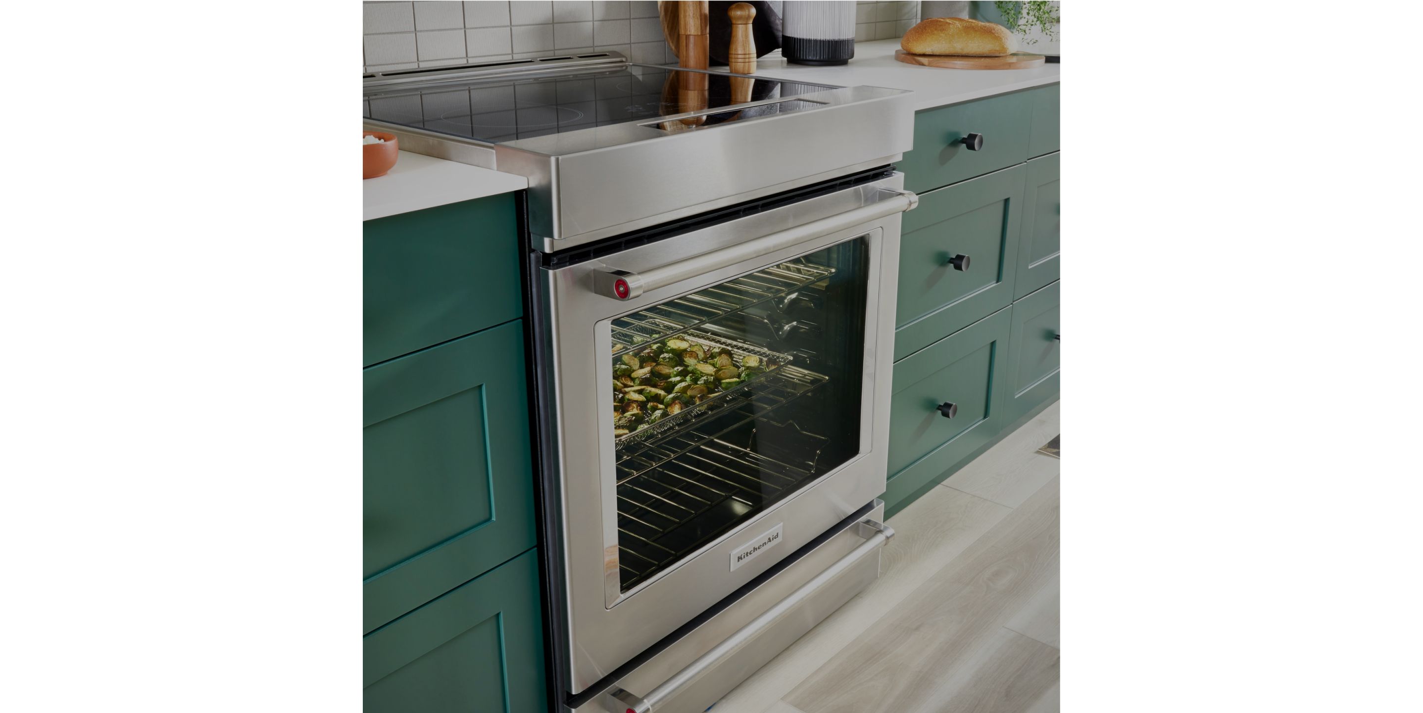 A KitchenAid® range with food cooking inside.