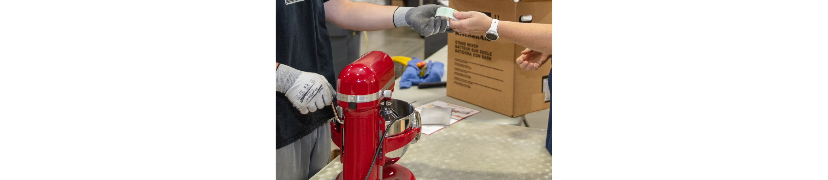 Technician testing a refurbished KitchenAid® mixer at the factory.