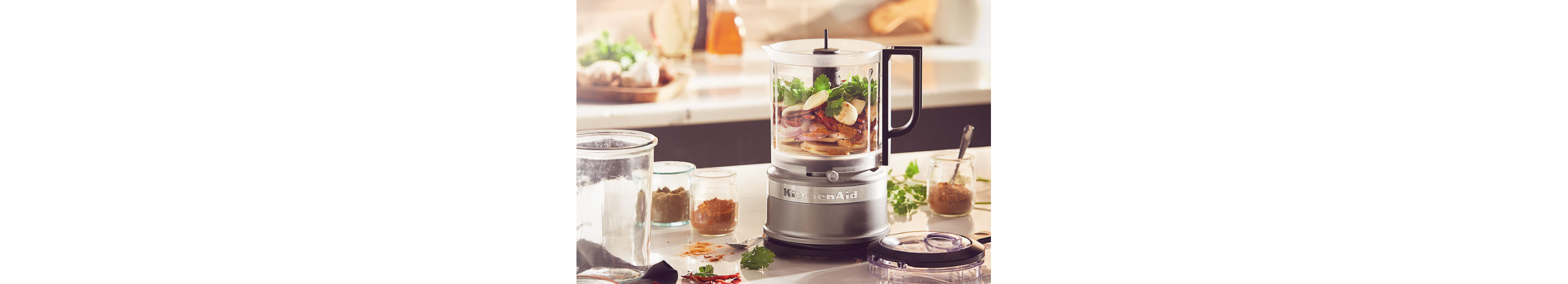 Silver refurbished food processor filled with ingredients.