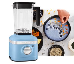 An overhead close-up Blueberry power
                              bowl in black bowl being
                              garnished