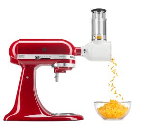 
                                    Red stand mixer with shredder attachment shredding cheddar cheese.
                                