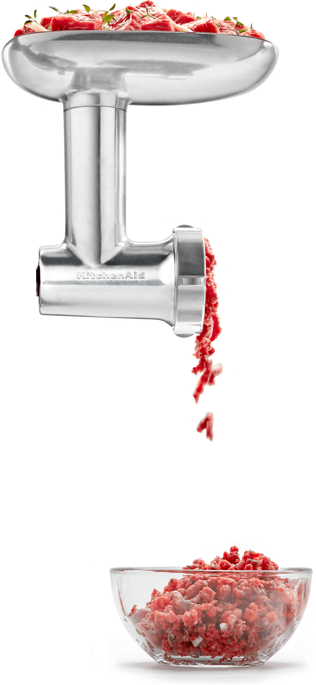 Fresh, cubed meat being processed through the grinder attachment with a variety of herbs.