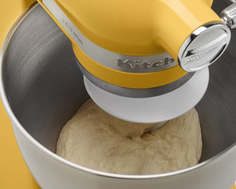 Closeup of Buttercup KitchenAid® stand mixer with bread dough