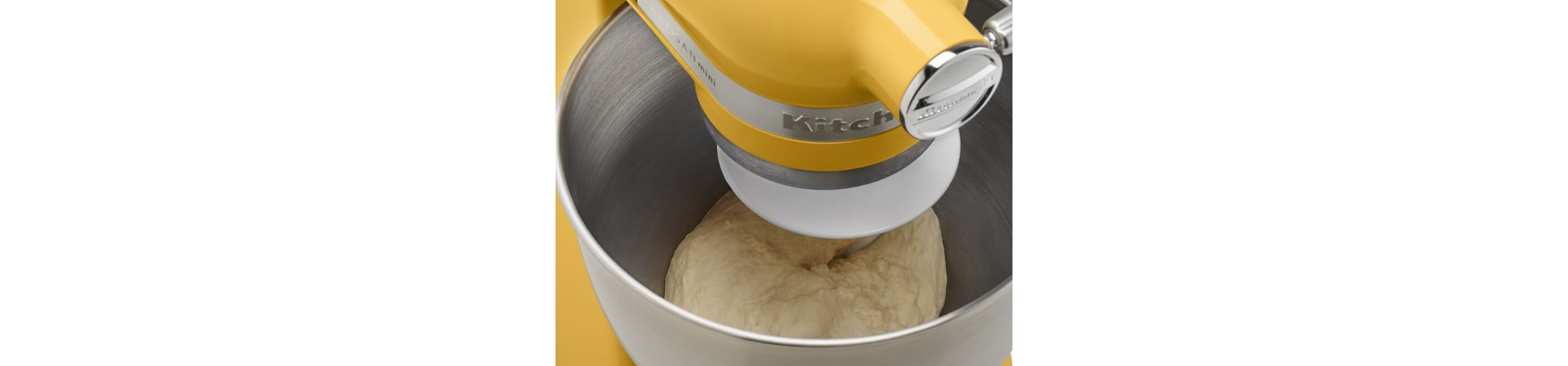 Closeup of Buttercup KitchenAid® stand mixer with bread dough