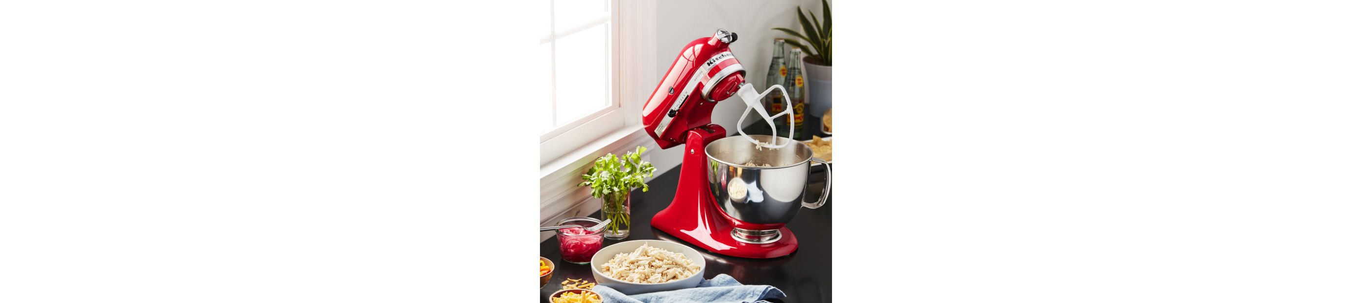 Passion Red KitchenAid® stand mixer with baking ingredients
