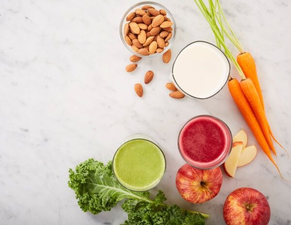 Fresh juices and almond milk with almonds, kale, carrots and apples