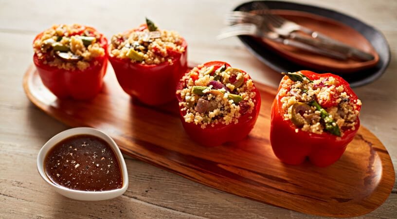 Red peppers stuffed with veggies and couscous