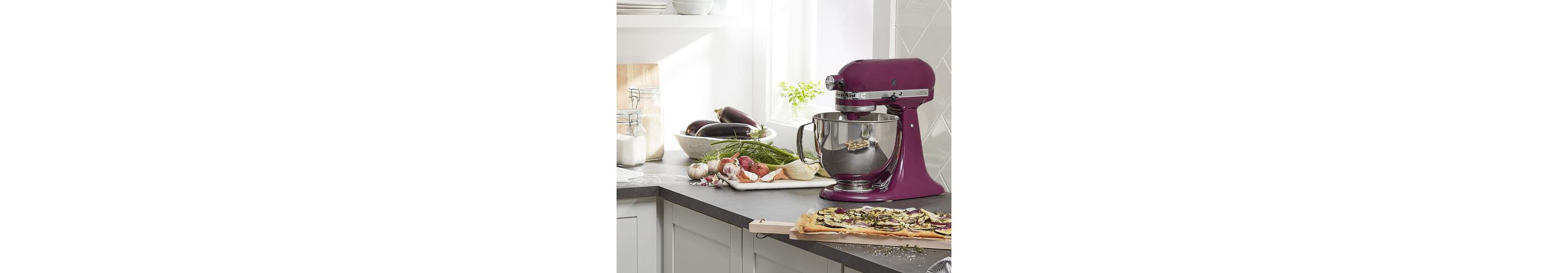 Boysenberry KitchenAid® stand mixer on a counter with eggplant, garlic and onion flatbread