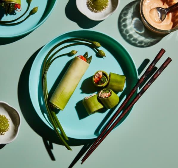 Spicy zucchini salmon roll on a teal plate