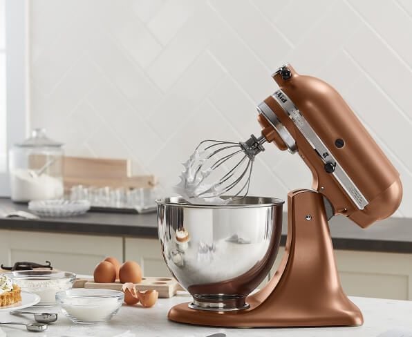 Copper Pearl KitchenAid® stand mixer on a counter with baking ingredients