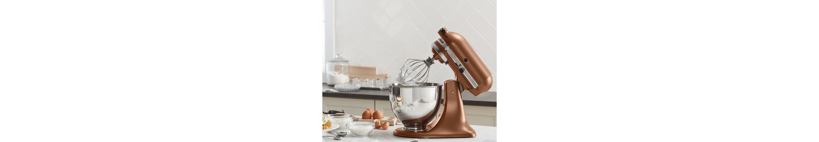 Copper Pearl KitchenAid® stand mixer on a counter with baking ingredients