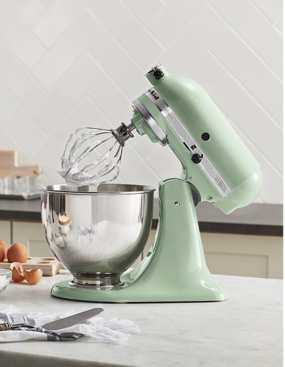 Pistachio KitchenAid® stand mixer on a counter with baking ingredients