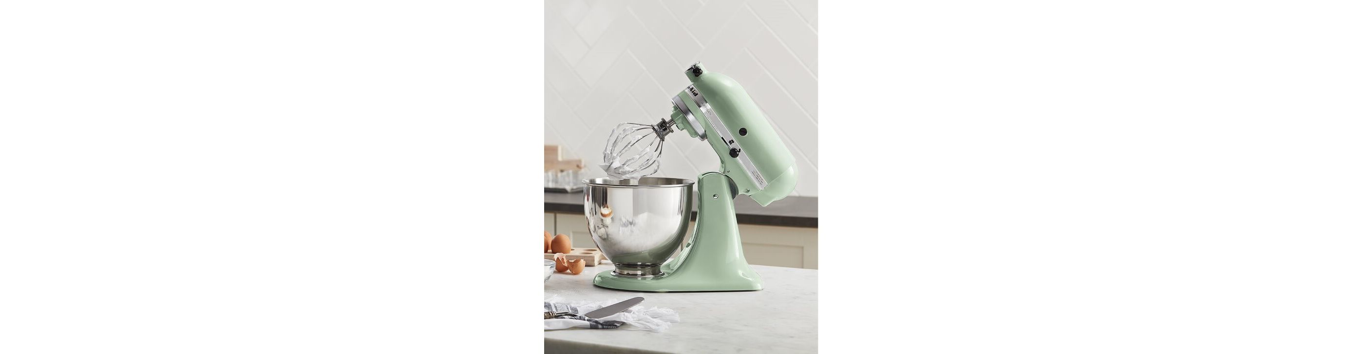Pistachio KitchenAid® stand mixer on a counter with baking ingredients