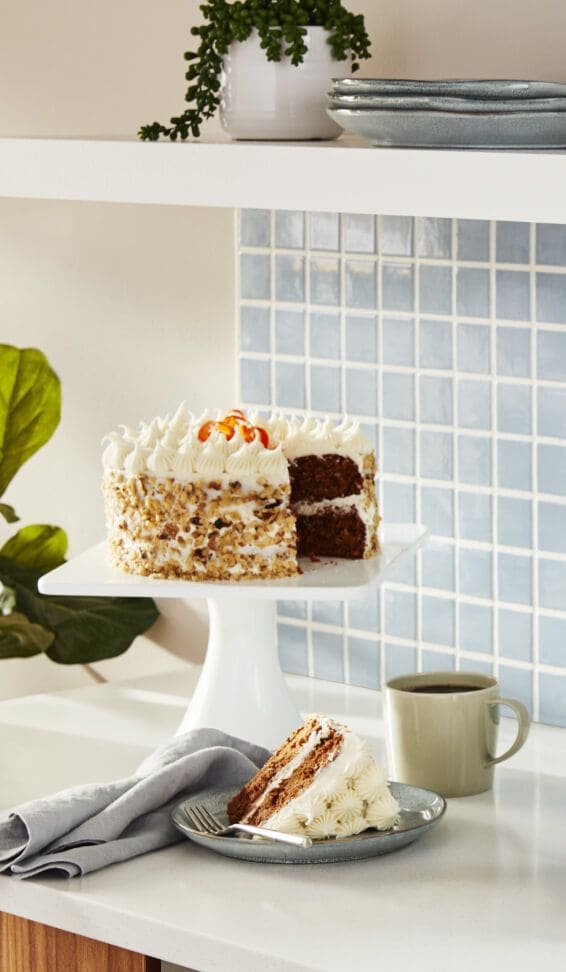 Frosted cake on a white cake stand