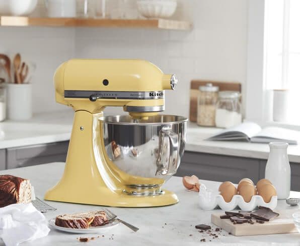 Majestic Yellow KitchenAid® stand mixer on a counter with baking ingredients