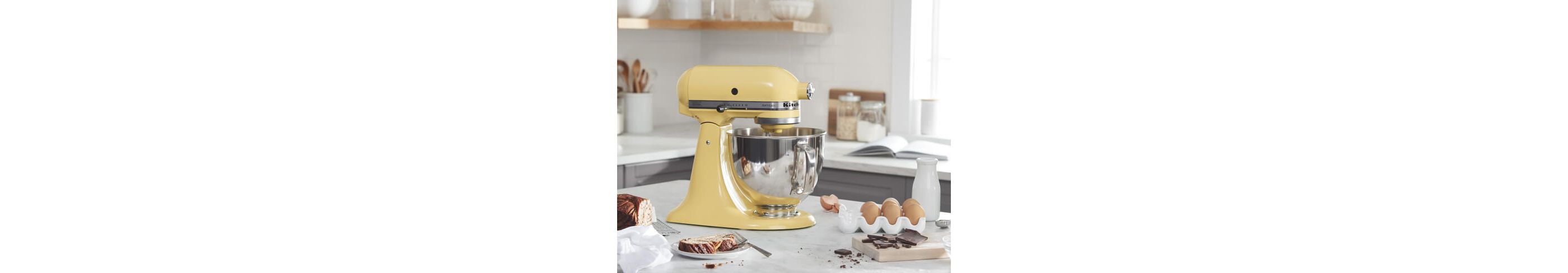 Majestic Yellow KitchenAid® stand mixer on a counter with baking ingredients