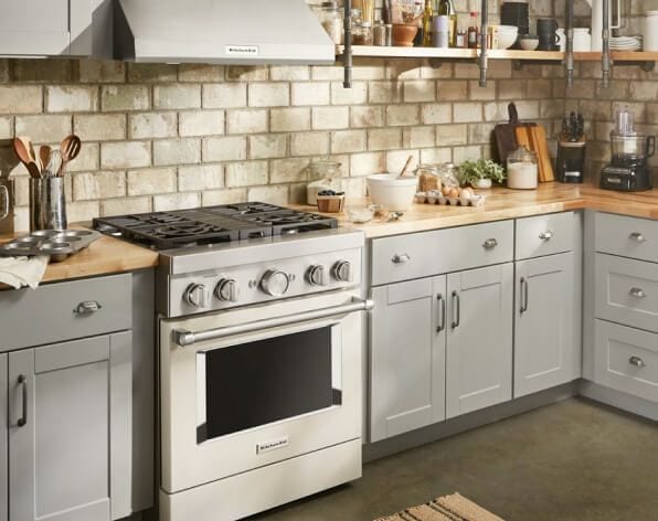 Light grey kitchen with butcher block countertops