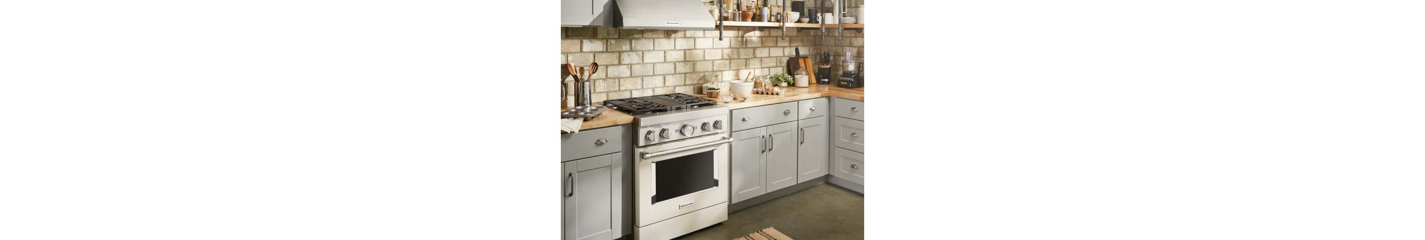 Light grey kitchen with butcher block countertops