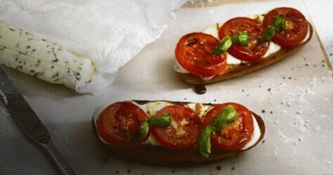 Plate with tomatoes and mozzarella cheese on toast.