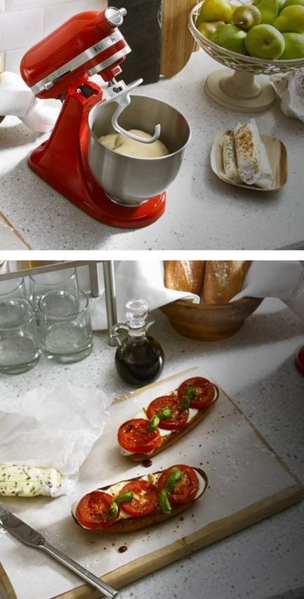 Red Stand Mixer with dough hook attached, and stainless steel bowl with dough in it, with a plate with tomatoes and mozzarella cheese on toast.