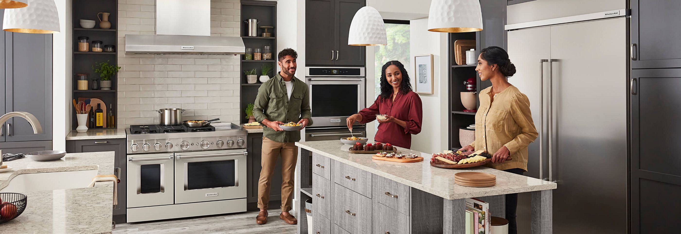 Three people cooking in the kitchen.