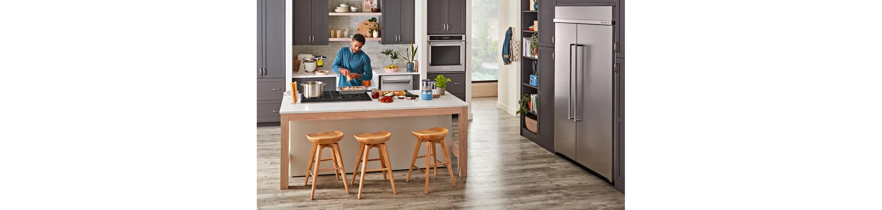 A person working in their kitchen.