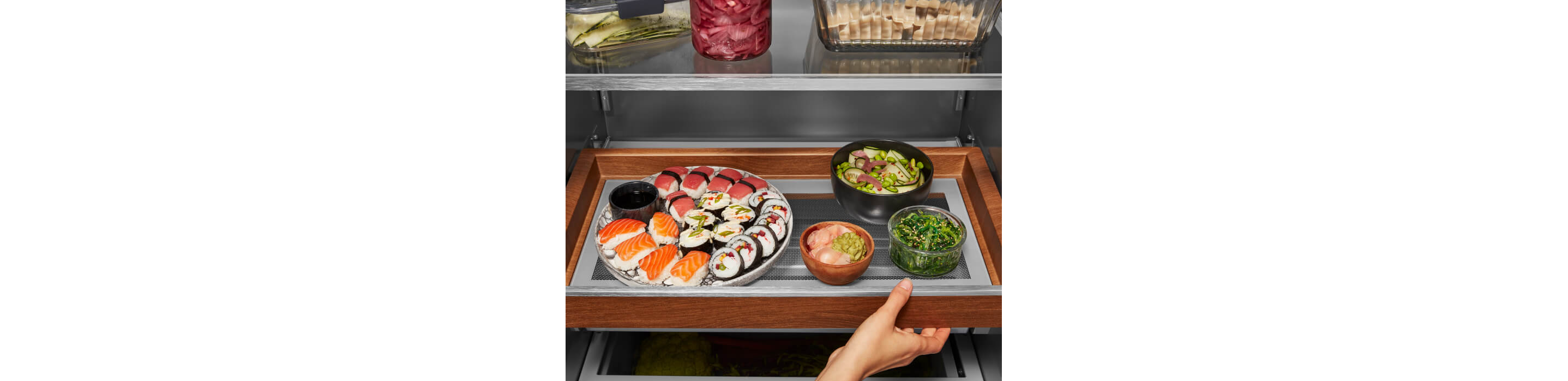KitchenAid® Built-In Side-by-Side Refrigerator Sliding Storage Tray holding a tray of sushi and other foods