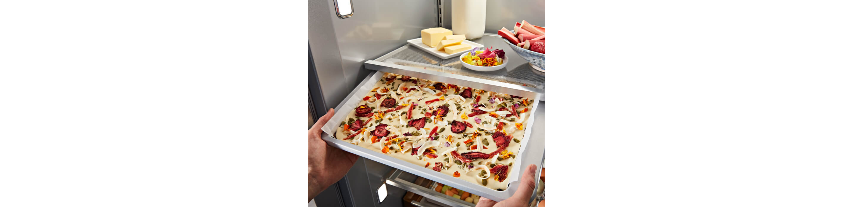 KitchenAid® Built-In Side-by-Side Refrigerator Under-Shelf Prep Zone holding a peach dessert  