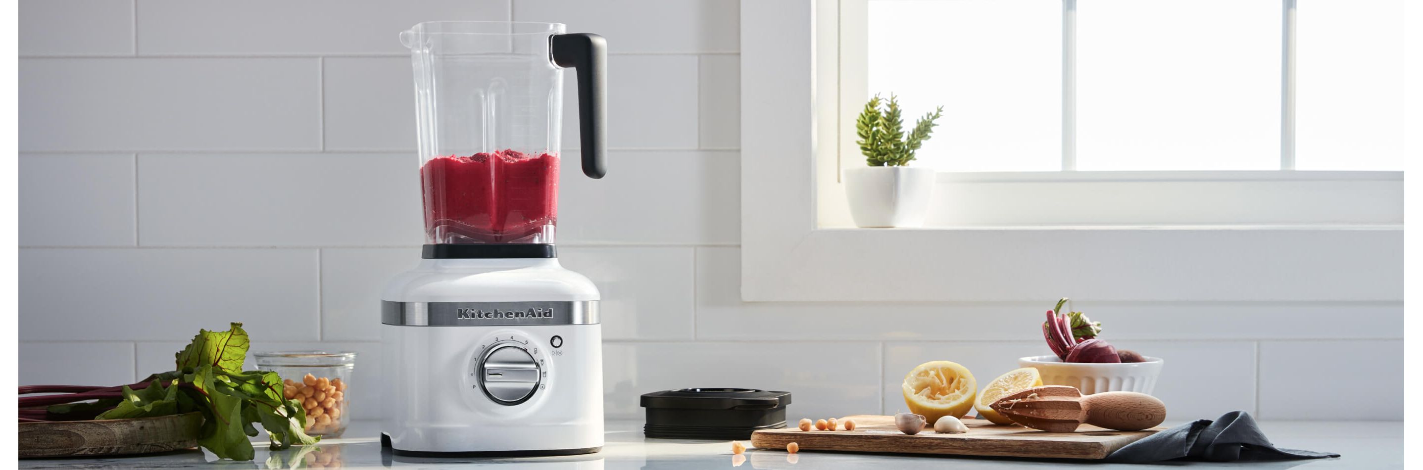An open White K400 Blender resting on a white countertop.