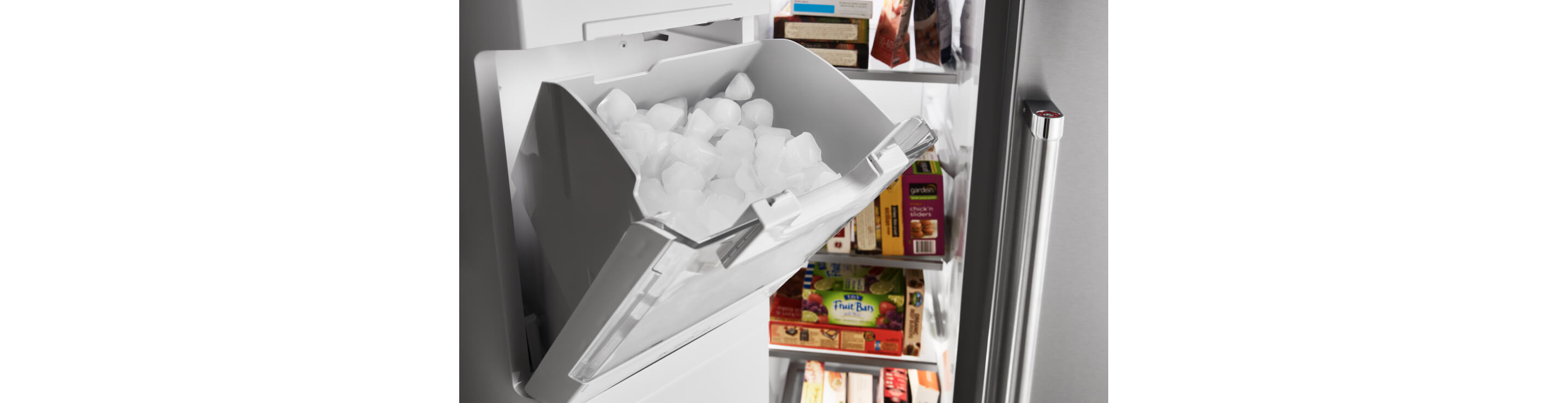 A full ice bin in a KitchenAid refrigerator.
