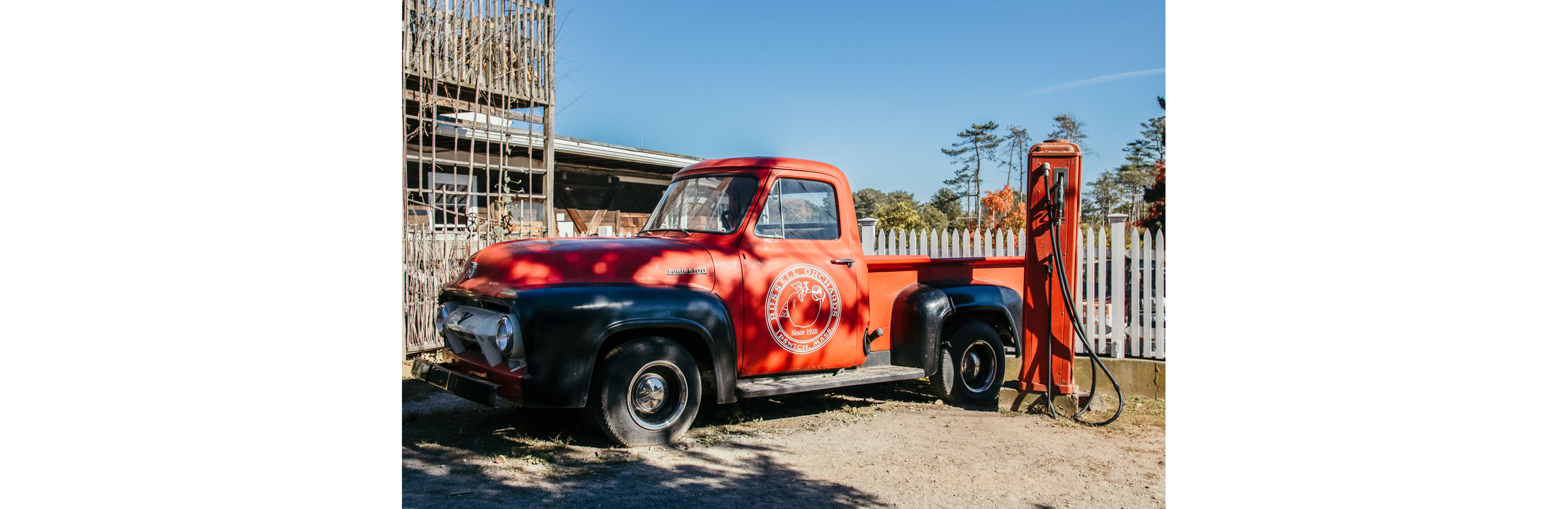 A red Russell Orchard pickup truck.