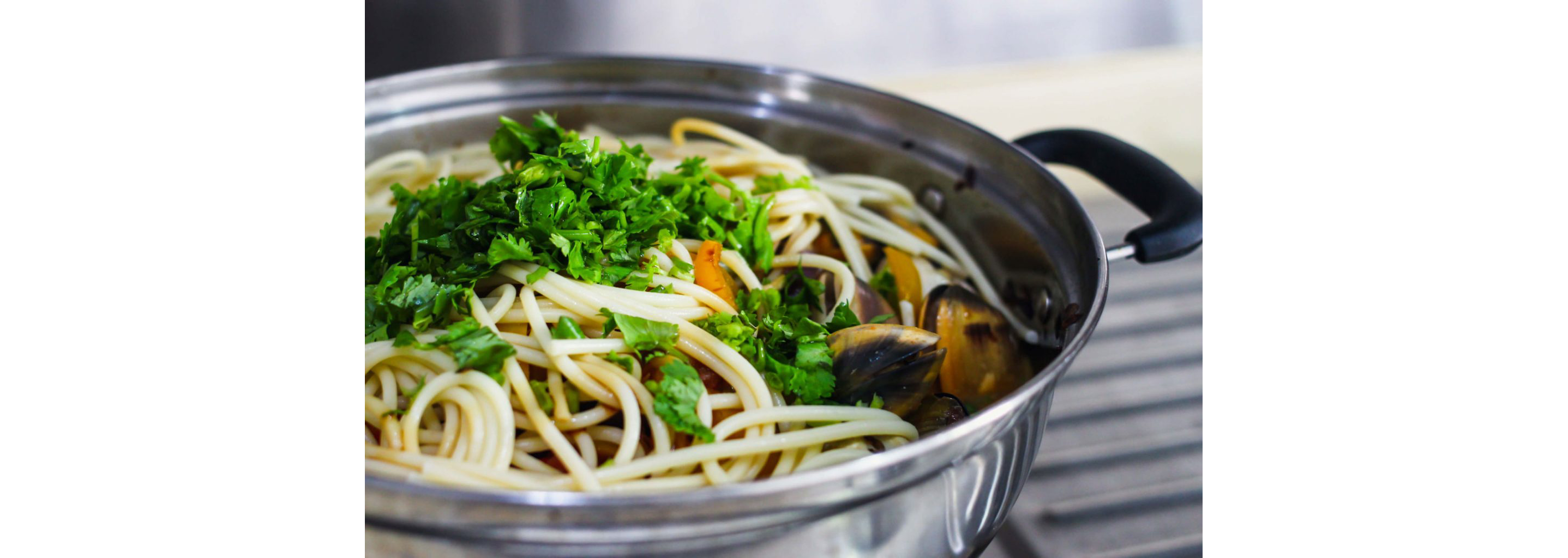 A large pot of cooked spaghetti.