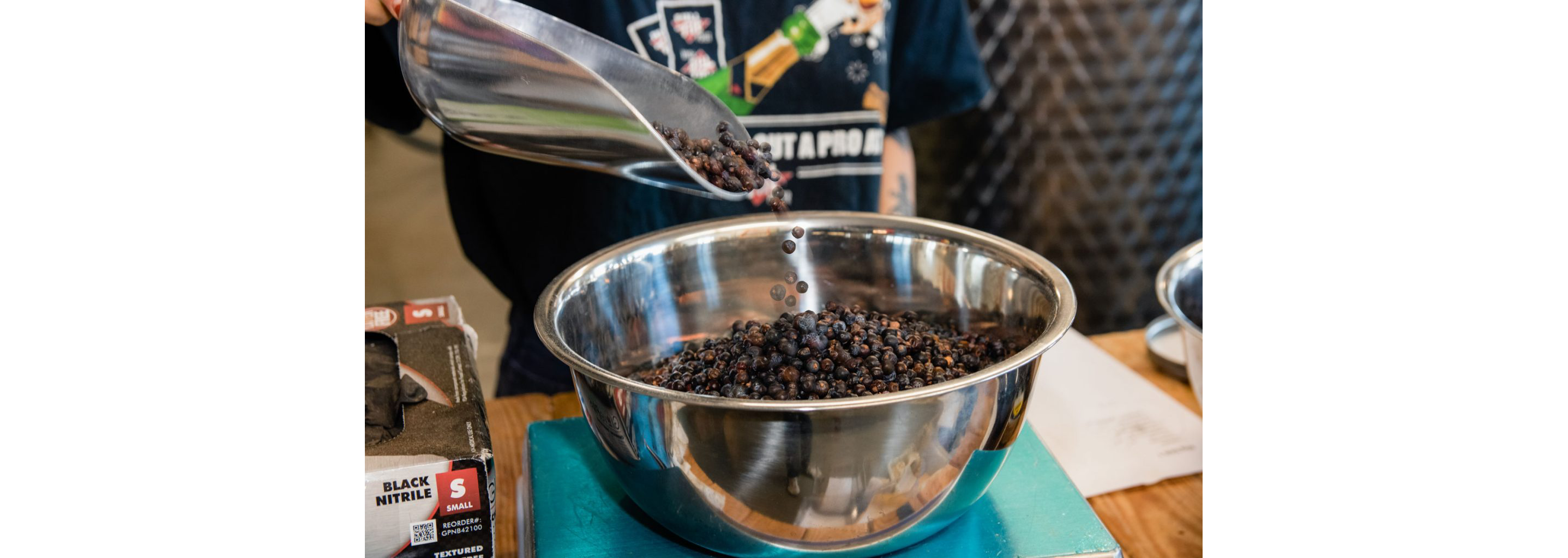 Dark herbs in a large metal bowl.