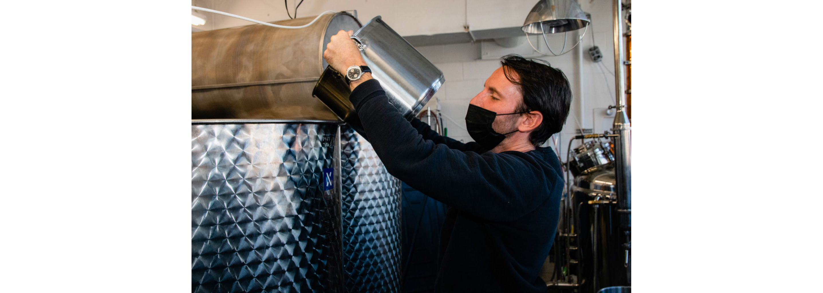 Daniel de la Nuez pouring a large pot into a larger pot.
