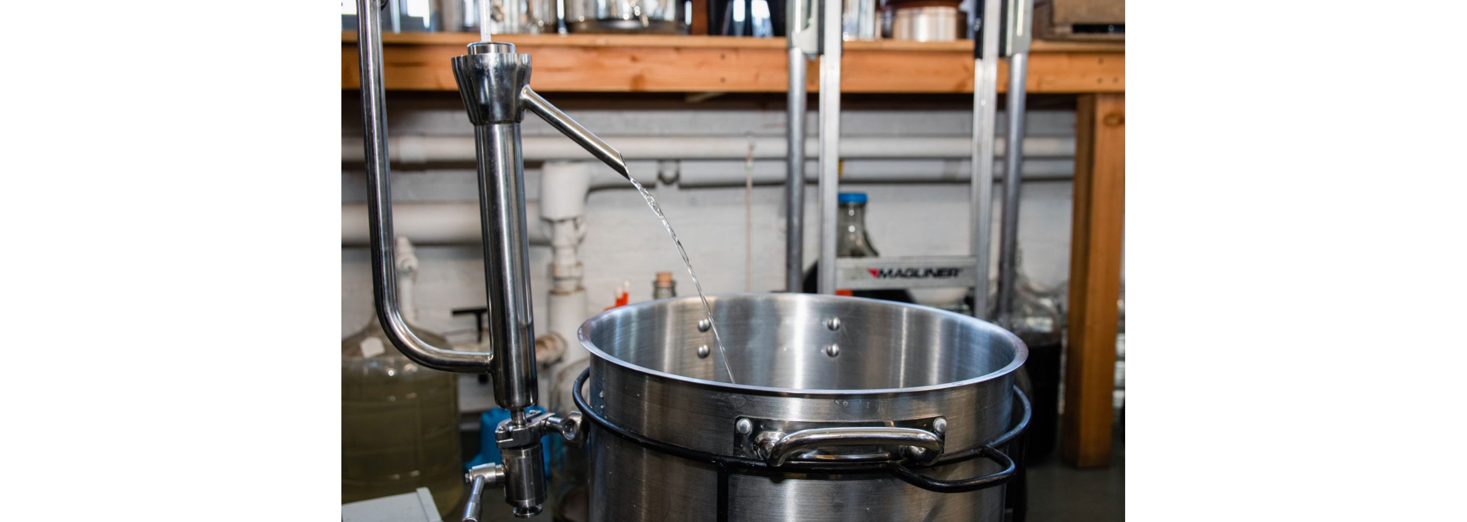 Distilled liquor pouring into a pot.