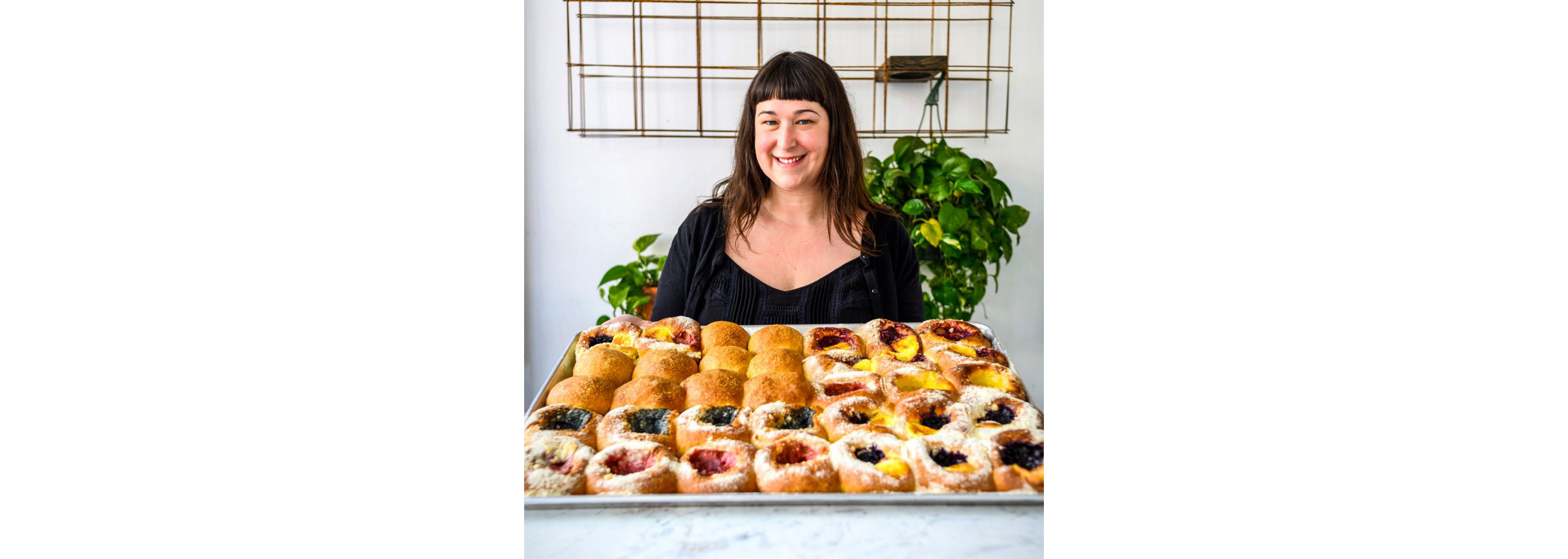 Autumn Stanford holding a tray of kolaches.