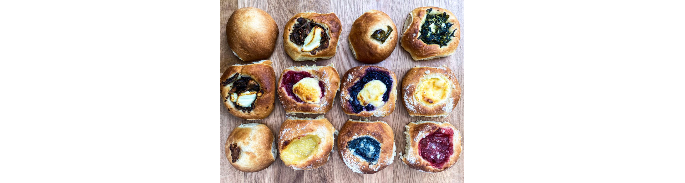 Kolaches resting on a cutting board.