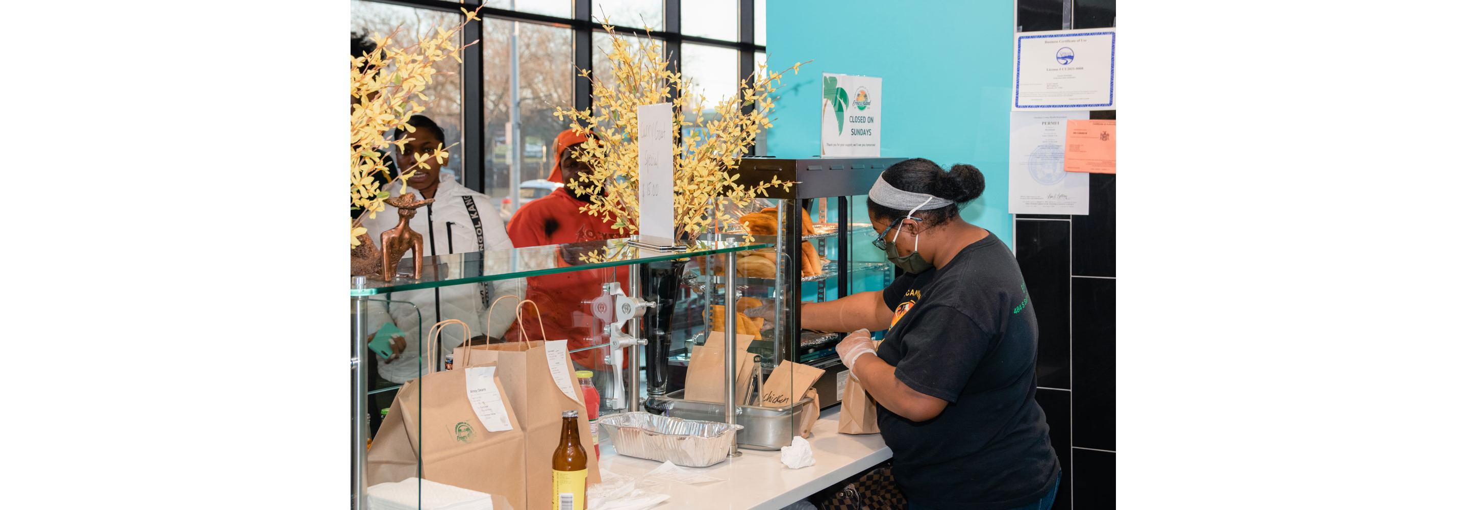 A woman filling out to go orders.