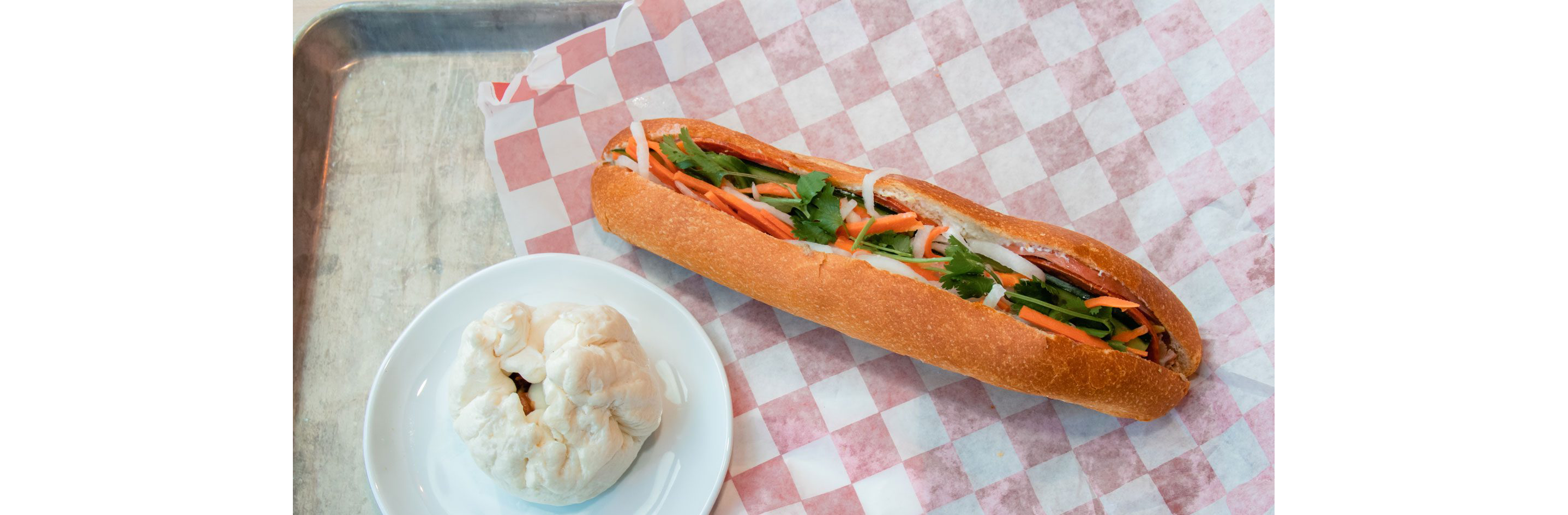 A large sandwich overflowing with its contents.