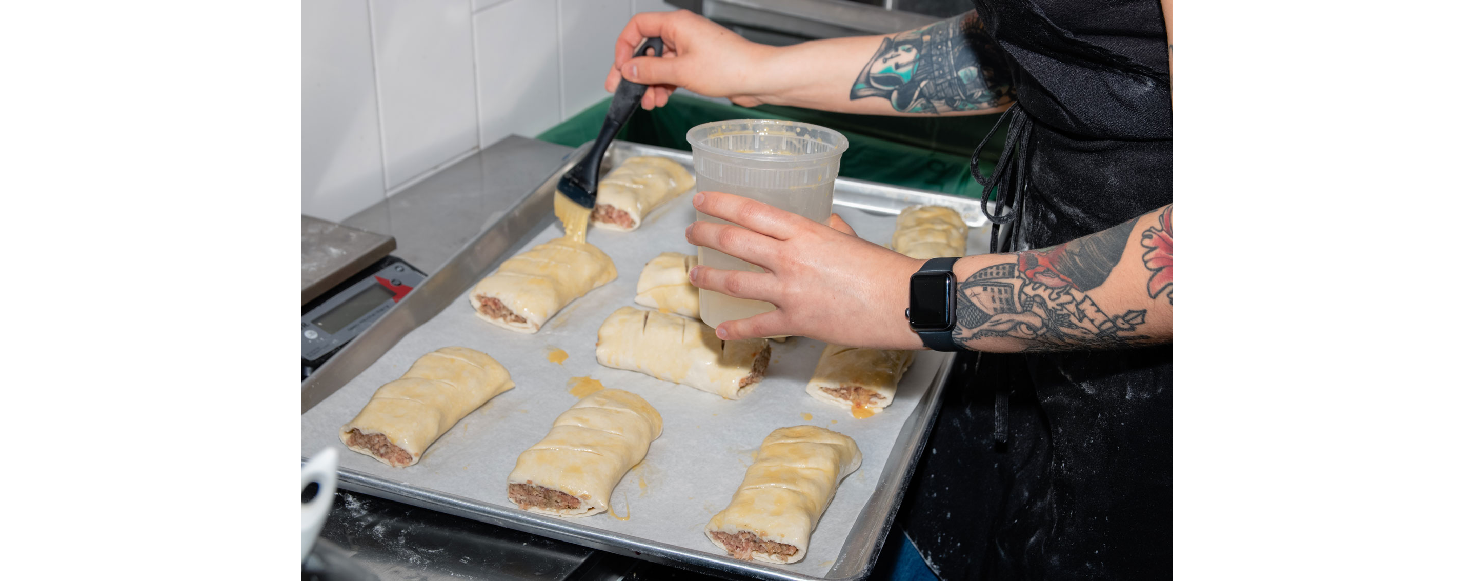 Small handheld pies being buttered.