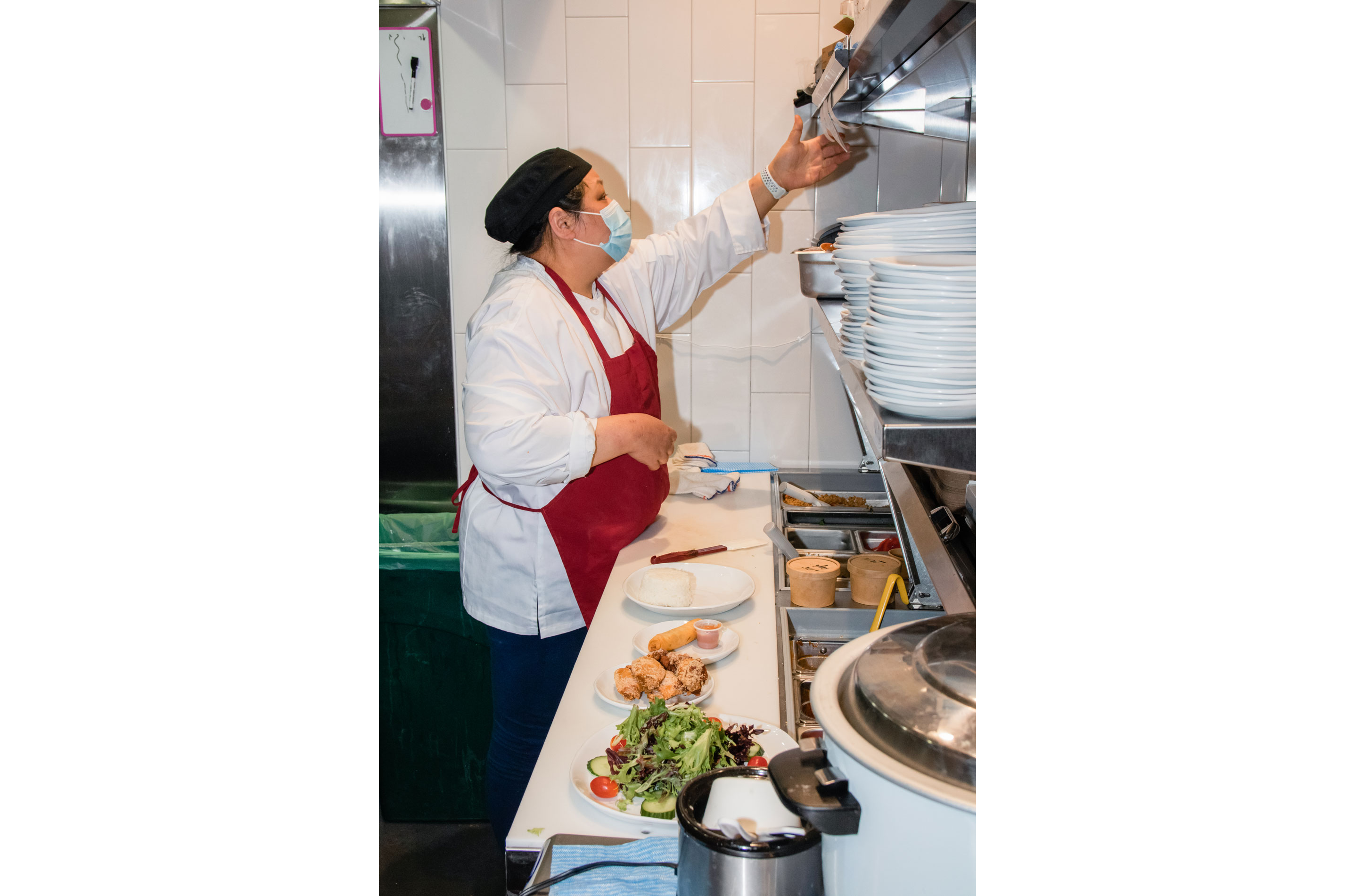 Sarinthra working in her kitchen.
