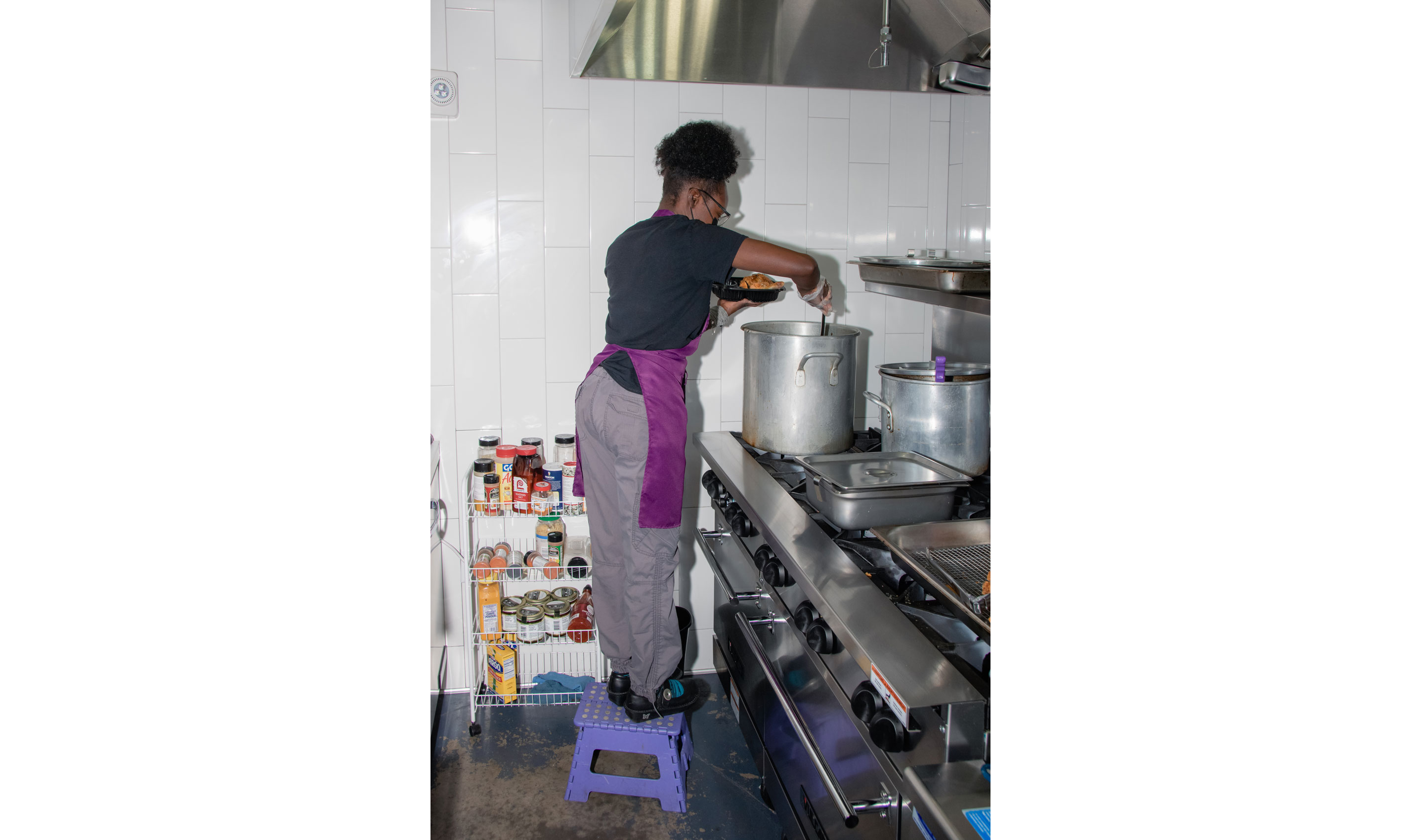 Dreamer serving food from a large pot.