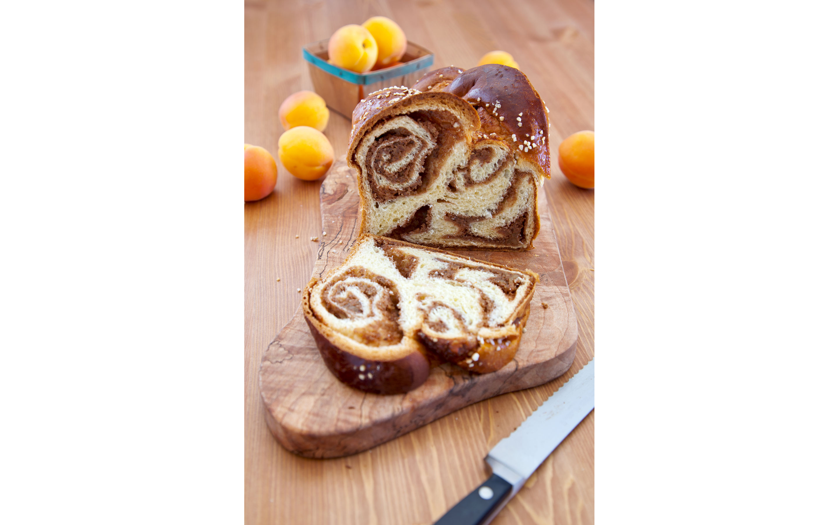 A slice of cinnamon babka bread resting on a wooden cutting board.