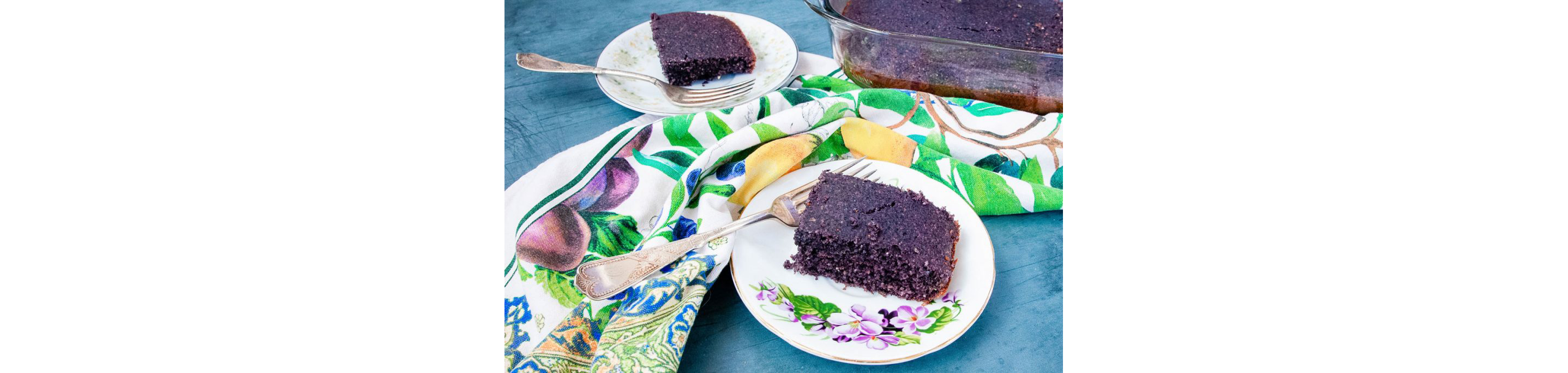 Slices of blue corn bread resting on delicate little plates.