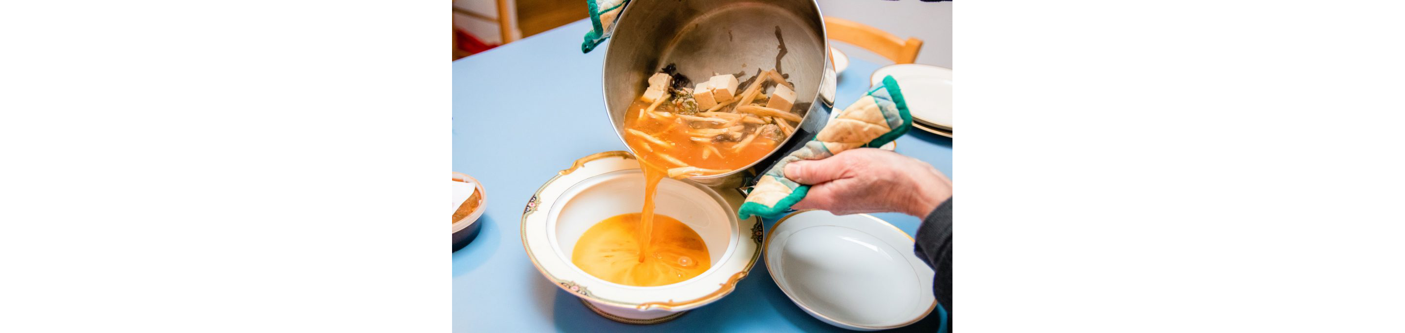 A person making take-and-make kit of soup.