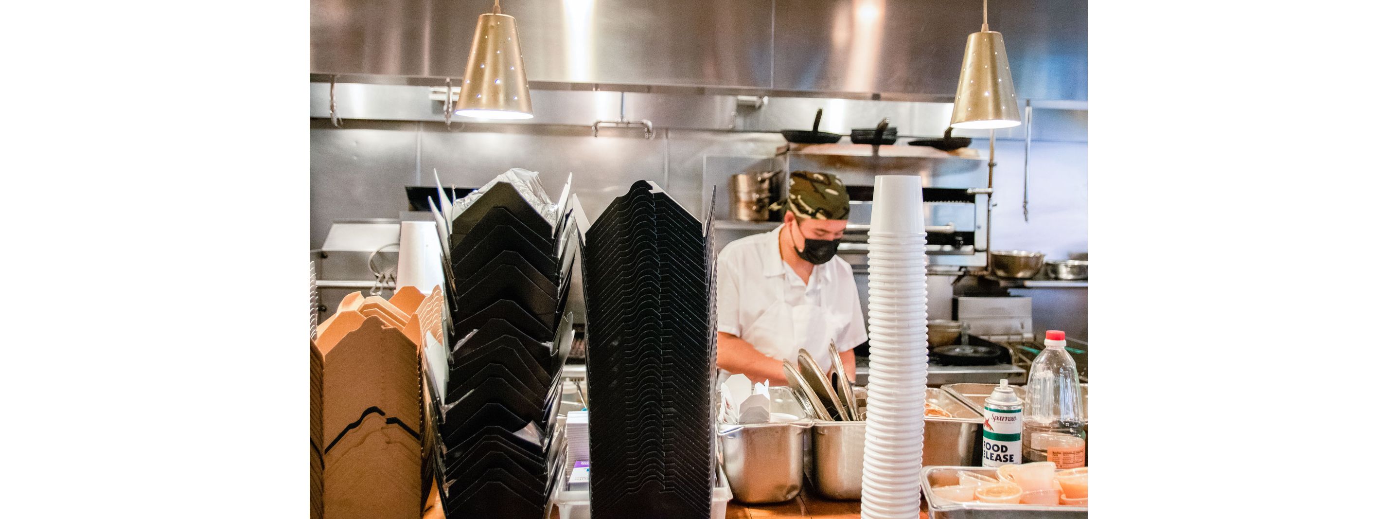 A chef working in the restaurant kitchen of Myers + Chang.